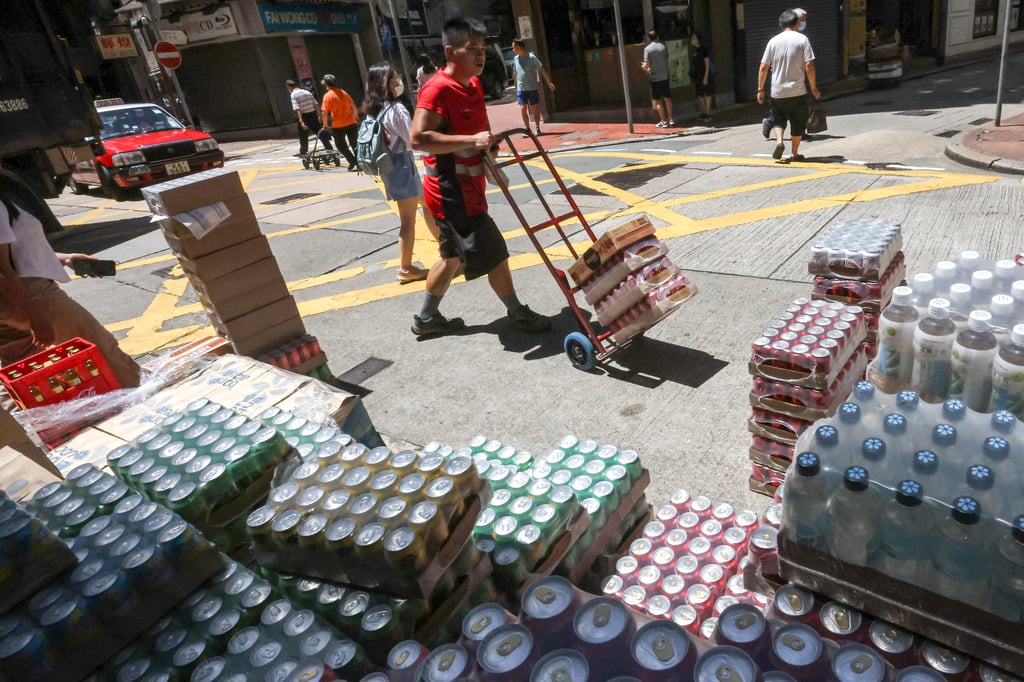 A worker delivers bottled drinks in Sheung Wan on July 11, 2023. Photo: Jonathan Wong A worker delivers bottled drinks in Sheung Wan on July 11, 2023. Photo: Jonathan Wong