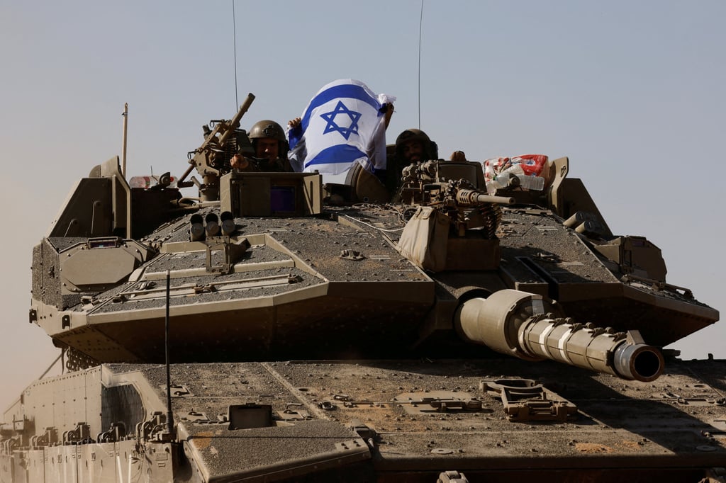 Israeli soldiers in a tank hold an Israeli flag near Israel’s border after leaving Gaza, during the temporary truce between the Palestinian Islamist group Hamas and Israel on November 24, 2023. Photo: Reuters Israeli soldiers in a tank hold an Israeli flag near Israel’s border after leaving Gaza, during the temporary truce between the Palestinian Islamist group Hamas and Israel on November 24, 2023. Photo: Reuters