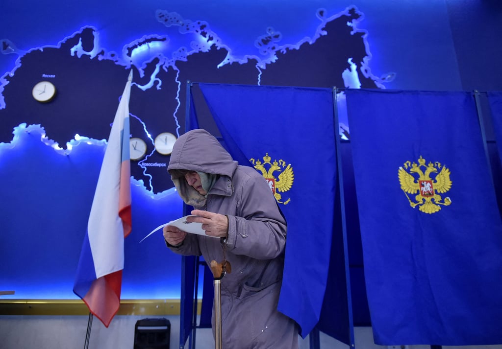 A woman studies her ballot in Novosibirsk, Russia. Photo: Reuters A woman studies her ballot in Novosibirsk, Russia. Photo: Reuters