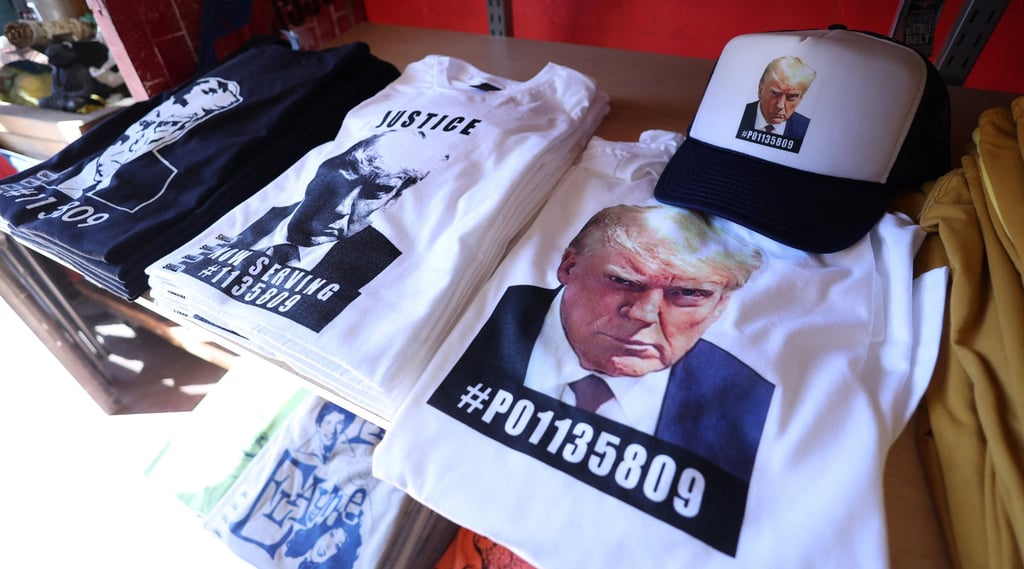 T-shirts and hats with an image depicting the mugshot of former US president Donald Trump are pictured after being printed at the Y-Que printing store in Los Angeles, California, in August 2023. Photo: Reuters T-shirts and hats with an image depicting the mugshot of former US president Donald Trump are pictured after being printed at the Y-Que printing store in Los Angeles, California, in August 2023. Photo: Reuters