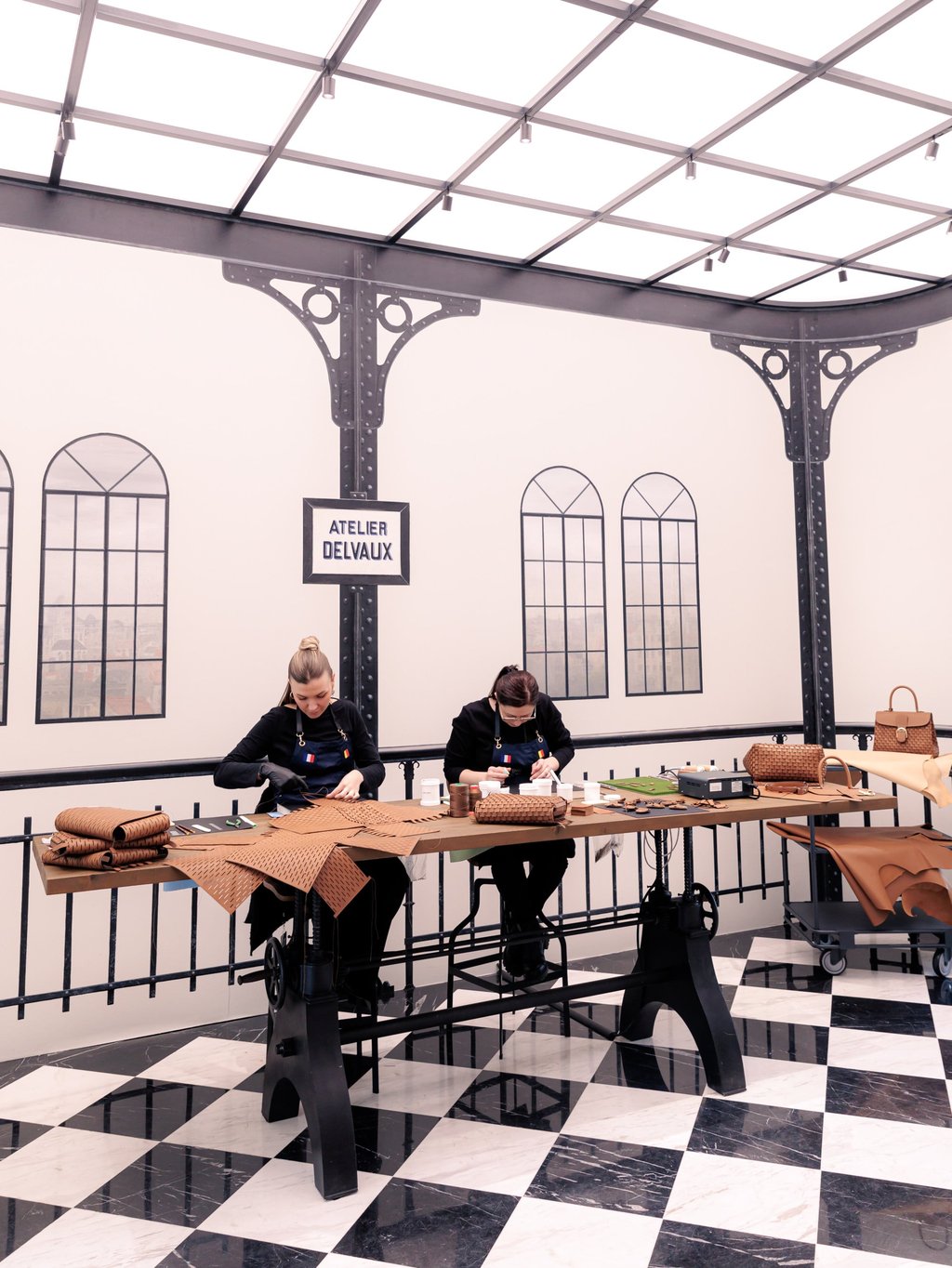Artisans demonstrate their skills at Delvaux autumn/winter 2024 Paris presentation during Paris Fashion Week