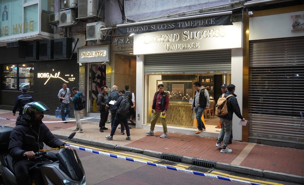 Police investigate the Legend Success Timepiece store. A video posted online shows three black-clad men, all wearing gloves, swinging into action when a woman customer enters the shop. Photo: Eugene Lee Police investigate the Legend Success Timepiece store. A video posted online shows three black-clad men, all wearing gloves, swinging into action when a woman customer enters the shop. Photo: Eugene Lee