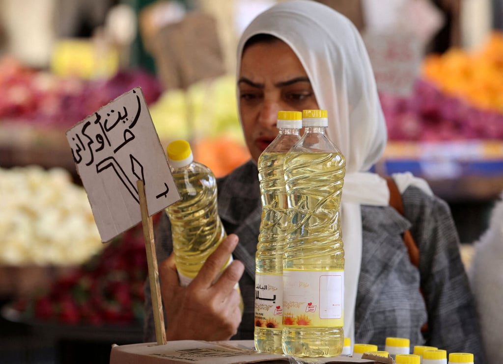 A woman buys food oil at a market in downtown Cairo, Egypt, on March 7. Photo: Reuters A woman buys food oil at a market in downtown Cairo, Egypt, on March 7. Photo: Reuters