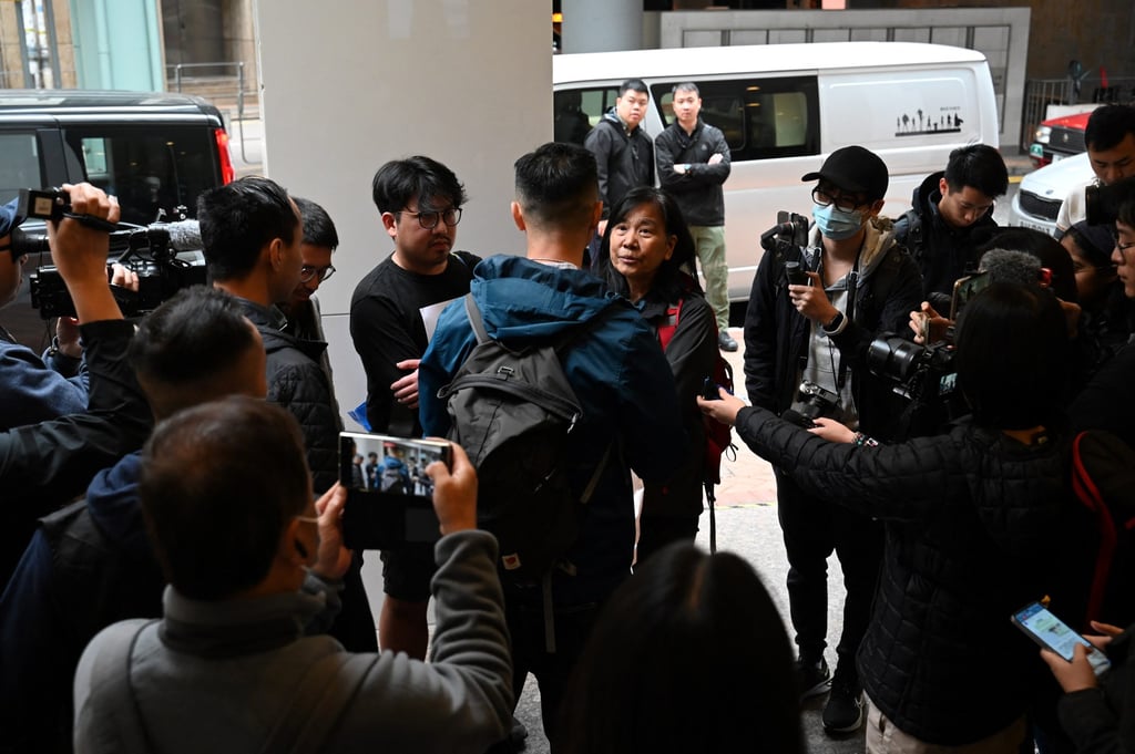 Chan Po Ying of the League of Social Democrats (rear, fourth from left) talks to police before holding the protest. Photo: AFP Chan Po Ying of the League of Social Democrats (rear, fourth from left) talks to police before holding the protest. Photo: AFP