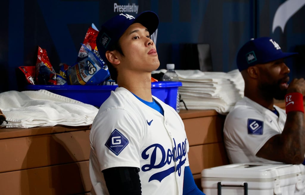 Shohei Ohtani sits in the dugout during the LA Dodgers’ season opener in Seoul. Photo: EPA-EFE