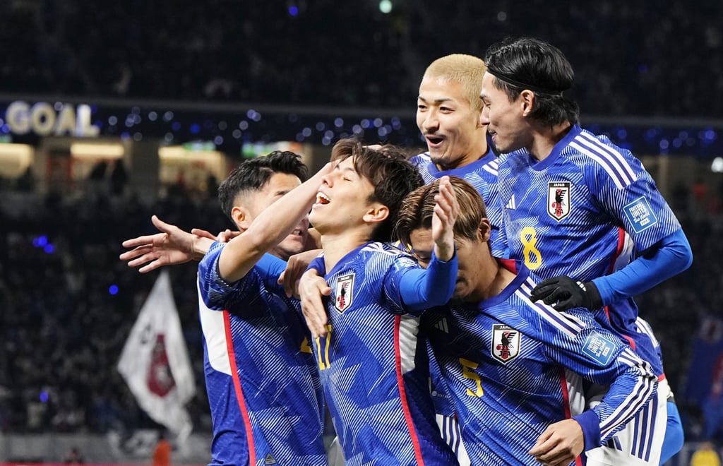 Ao Tanaka is mobbed after scoring Japan’s goal in their 1-0 win over North Korea. Photo: Kyodo