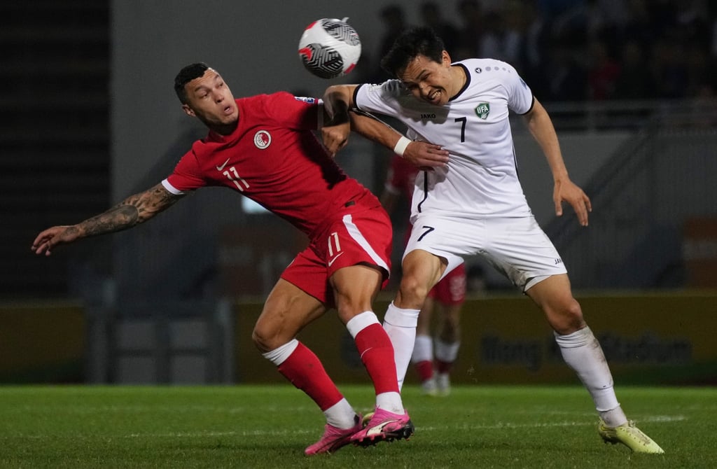 Hong Kong’s Everton Camargo (left) in a tussle with Shukurov Otabek of Uzbekistan. Photo: Elson Li Hong Kong’s Everton Camargo (left) in a tussle with Shukurov Otabek of Uzbekistan. Photo: Elson Li