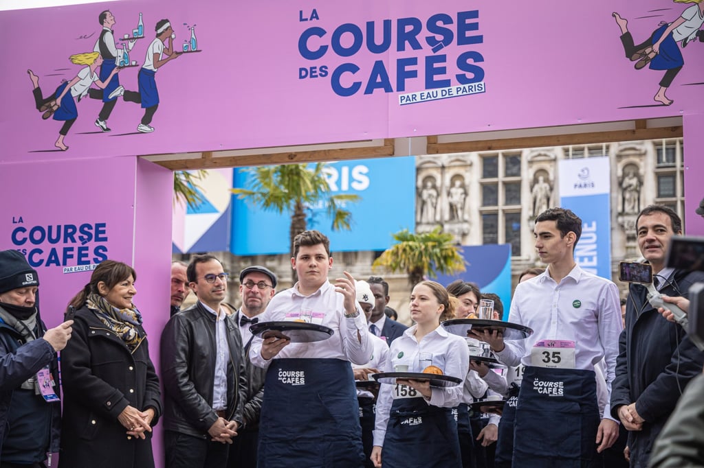 Paris Mayor Anne Hidalgo, second left, looks on as waiters prepare to take part in the waiters’ race (Course des Cafes), in Paris, France on Sunday. Photo: EPA-EFE Paris Mayor Anne Hidalgo, second left, looks on as waiters prepare to take part in the waiters’ race (Course des Cafes), in Paris, France on Sunday. Photo: EPA-EFE