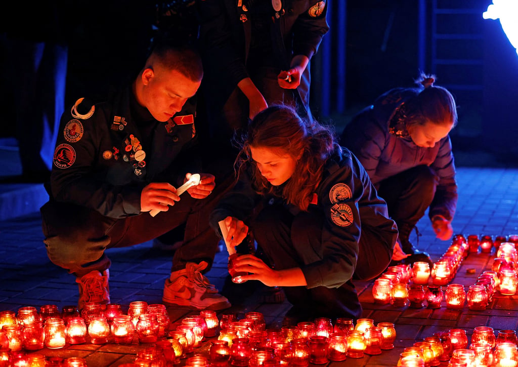People in Donetsk, Russian-controlled Ukraine on Sunday light candles during a vigil in memory of the victims of Friday’s shooting at Crocus City Hall, Moscow. Photo: Reuters