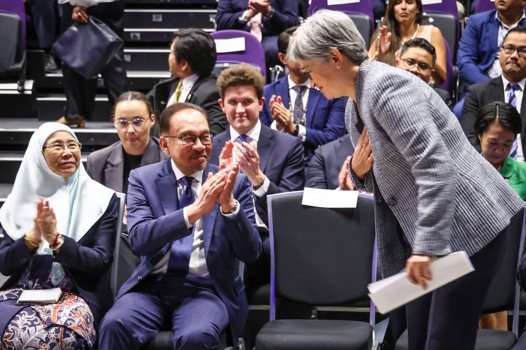 Malaysia’s Prime Minister Anwar Ibrahim (centre) and his wife Wan Azizah Ismail (left) clap as Australian Foreign Minister Penny Wong (right) gets up to speak during an event at the Australian National University in Canberra on March 7. Photo: AFP