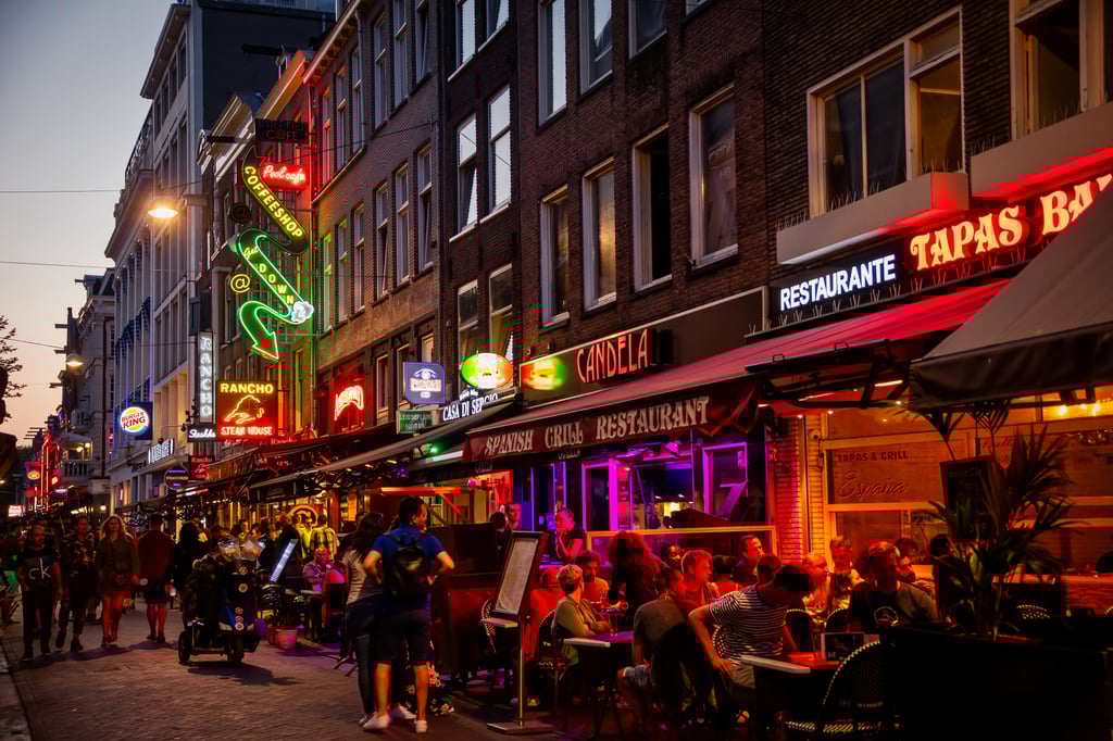 Brightly lit bars in Amsterdam. Authorities in the Dutch city have been trying to dissuade young, boisterous tourists from drunken revelry. Photo: Shutterstock Brightly lit bars in Amsterdam. Authorities in the Dutch city have been trying to dissuade young, boisterous tourists from drunken revelry. Photo: Shutterstock