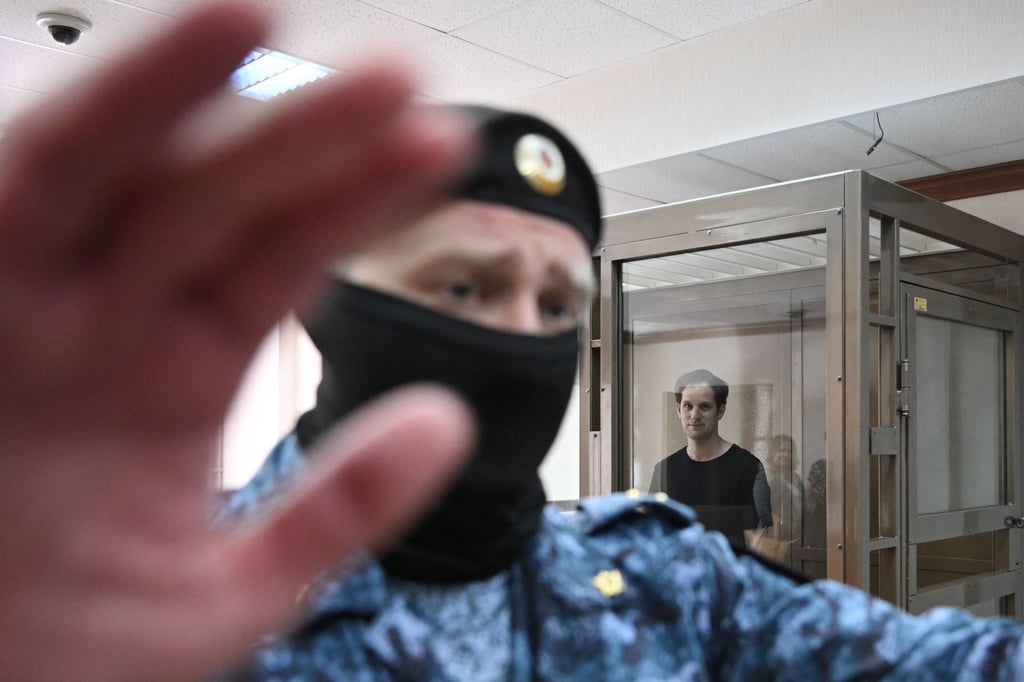 US journalist Evan Gershkovich stands in a defendants’ cage before a hearing at the Moscow City Court in June 2023. Photo: AFP