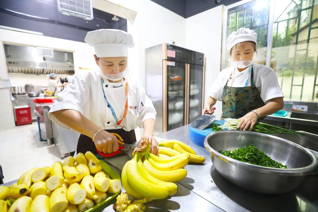 Workers prepare food at a community canteen for the elderly in Chongqing, China in July 2023. Photo: CFOTO/Future Publishing via Getty Images Workers prepare food at a community canteen for the elderly in Chongqing, China in July 2023. Photo: CFOTO/Future Publishing via Getty Images