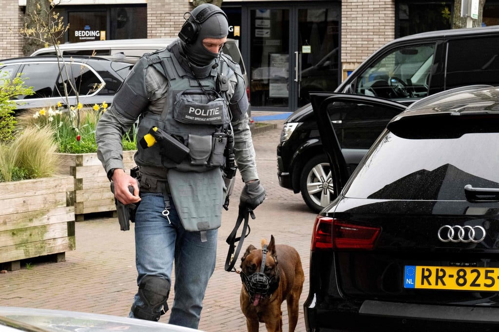 A police special intervention forces member with a canine unit after a hostage situation at Cafe Petticoat in Ede, Netherlands on Saturday. Photo: AFP A police special intervention forces member with a canine unit after a hostage situation at Cafe Petticoat in Ede, Netherlands on Saturday. Photo: AFP