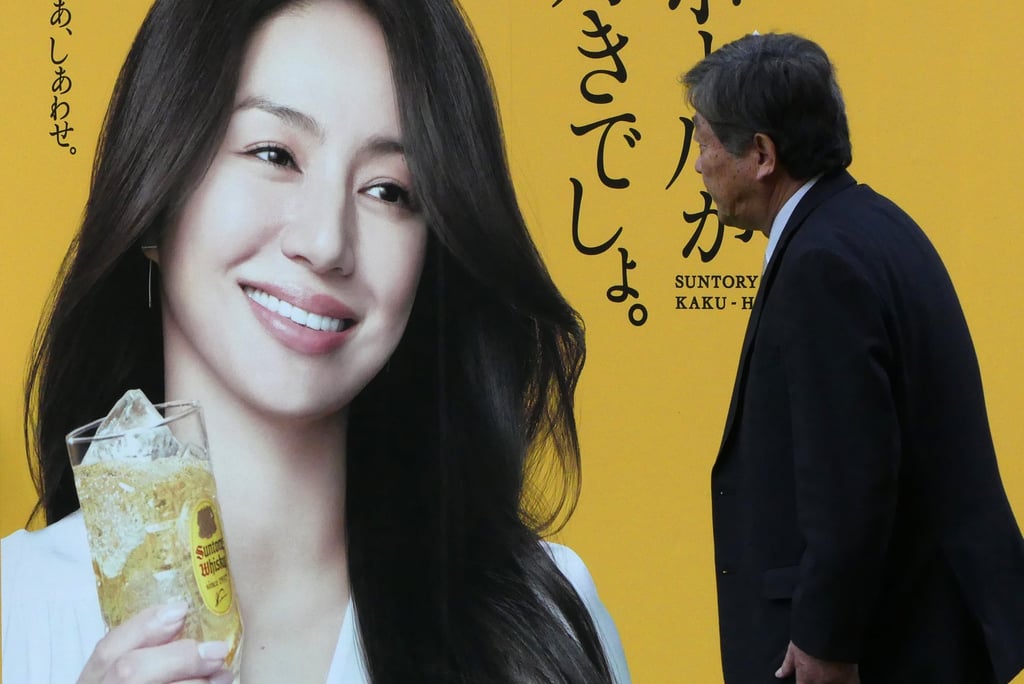 A man walks past an advertisement about whisky in Tokyo. Experts say Japan has around 100 distilleries, whose whisky has commanded increasing global respect since the early 2000s. Photo: Getty Images A man walks past an advertisement about whisky in Tokyo. Experts say Japan has around 100 distilleries, whose whisky has commanded increasing global respect since the early 2000s. Photo: Getty Images
