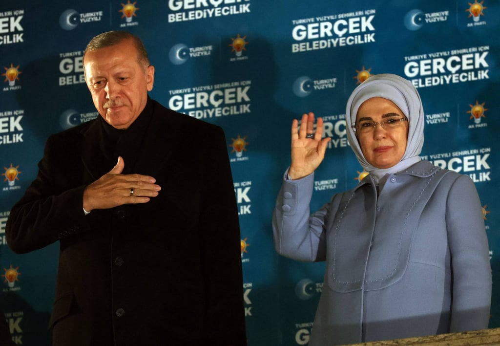 Turkish President Recep Tayyip Erdogan with his wife Emine Erdogan wave to supporters. Photo: AFP
