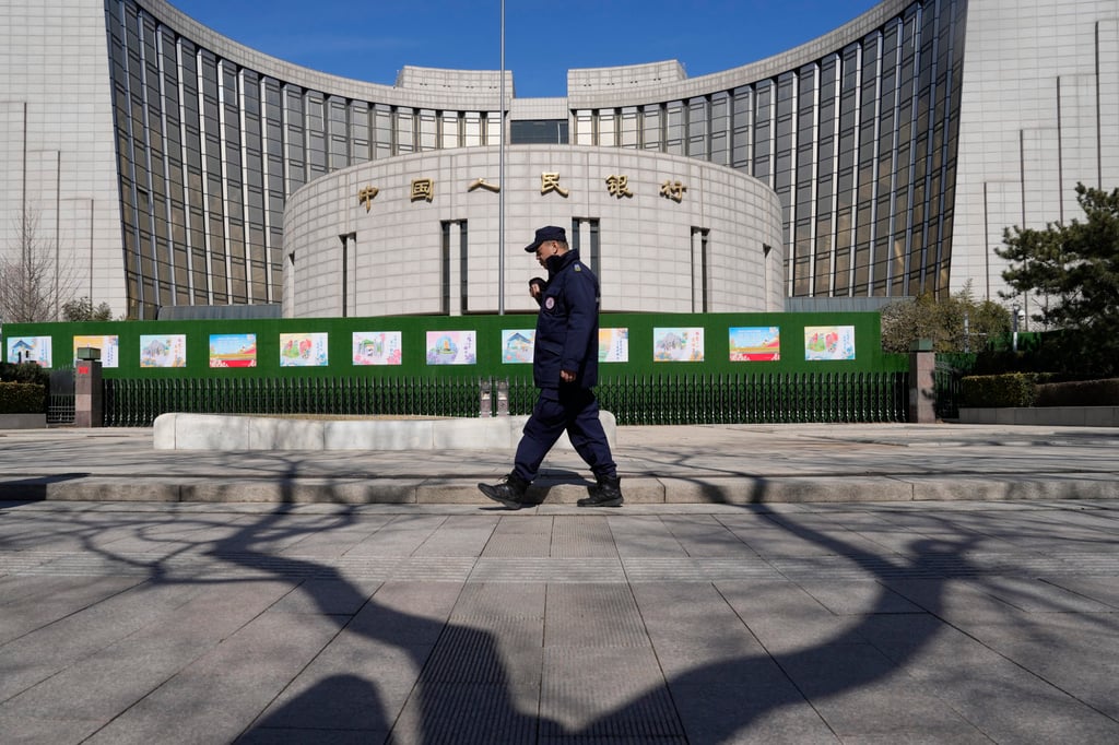 A security guard walks outside the People’s Bank of China headquarters in Beijing on March 6, 2024. Photo: AP