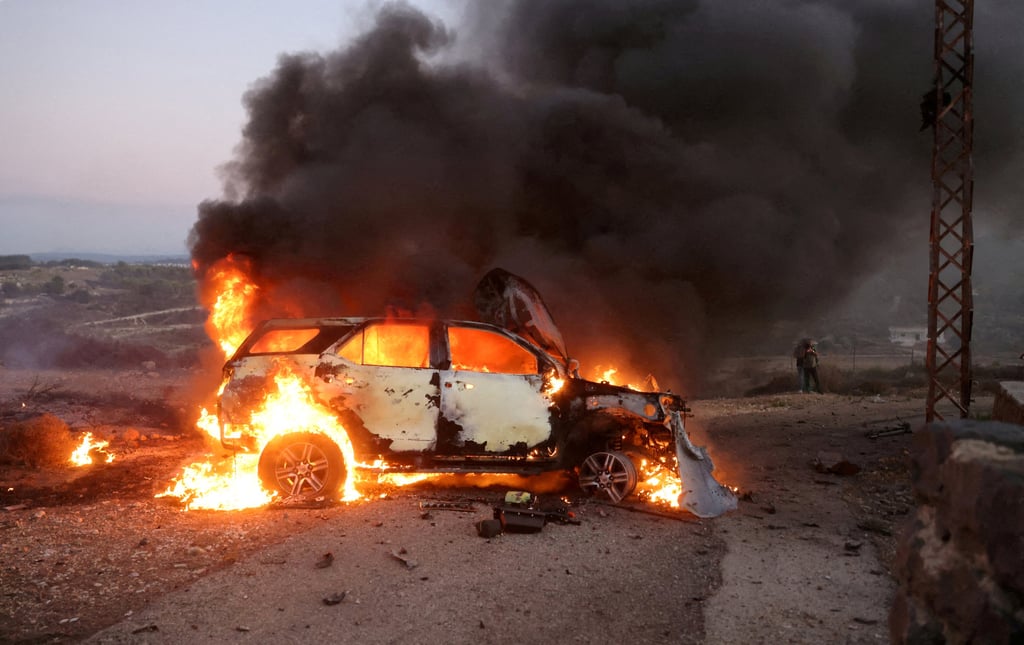 A car belonging to an Al Jazeera team burns at the site where a Reuters journalist was killed and six others were wounded by tank rounds fired from Israel, in Alma al-Chaab, Lebanon, near the border with Israel on October 13. Photo: Reuters