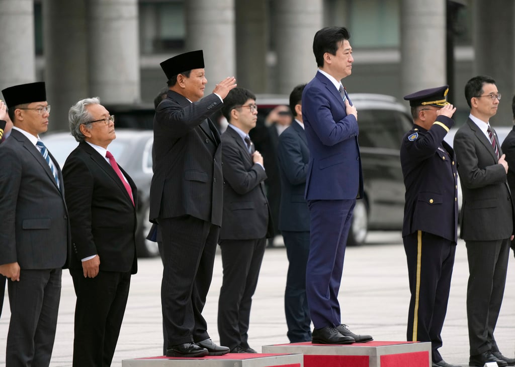 Indonesian Defence Minister Prabowo Subianto (third from left) receives the guard of honour with Japanese counterpart Minoru Kihara (third from right) at the defence ministry in Tokyo, Japan, on Wednesday. Photo: Pool via AP Indonesian Defence Minister Prabowo Subianto (third from left) receives the guard of honour with Japanese counterpart Minoru Kihara (third from right) at the defence ministry in Tokyo, Japan, on Wednesday. Photo: Pool via AP