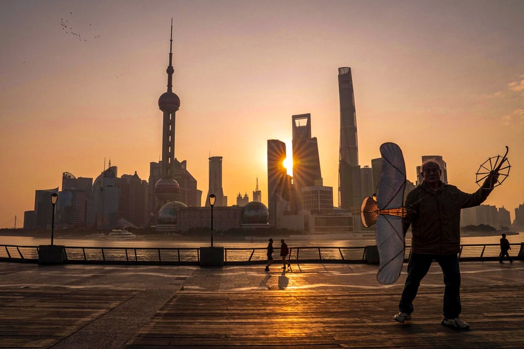 A pedestrian flies a kite in front of buildings in Pudong's Lujiazui Financial District in Shanghai, China, on February 19, 2024. Photo: Bloomberg
