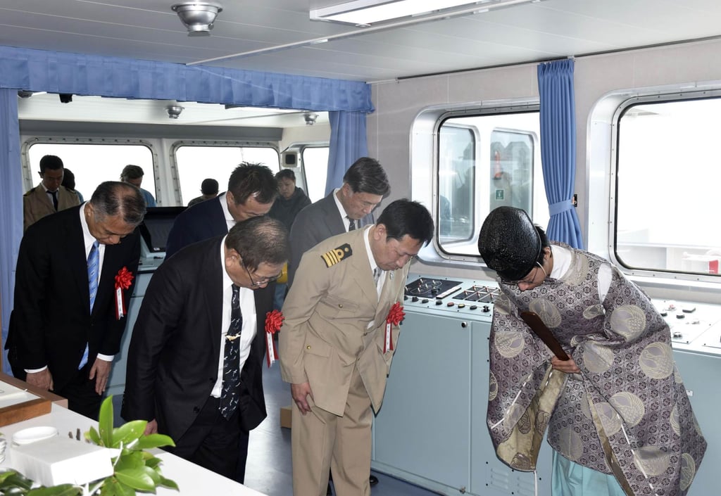 A priest prays during a ceremony inside the Kangei Maru, the world’s only whaling factory ship, in Shimonoseki, western Japan, on March 29. Photo: Kyodo