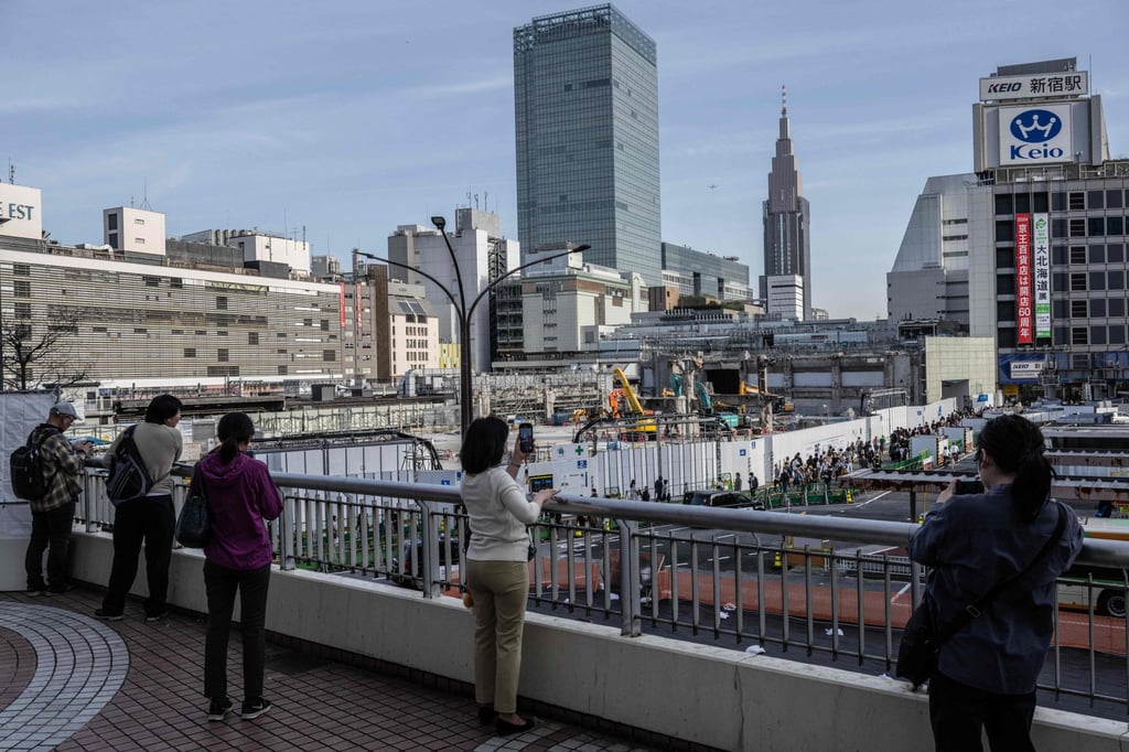 People take pictures in the Shinjuku area of Tokyo on March 30, 2024. Photo: AFP