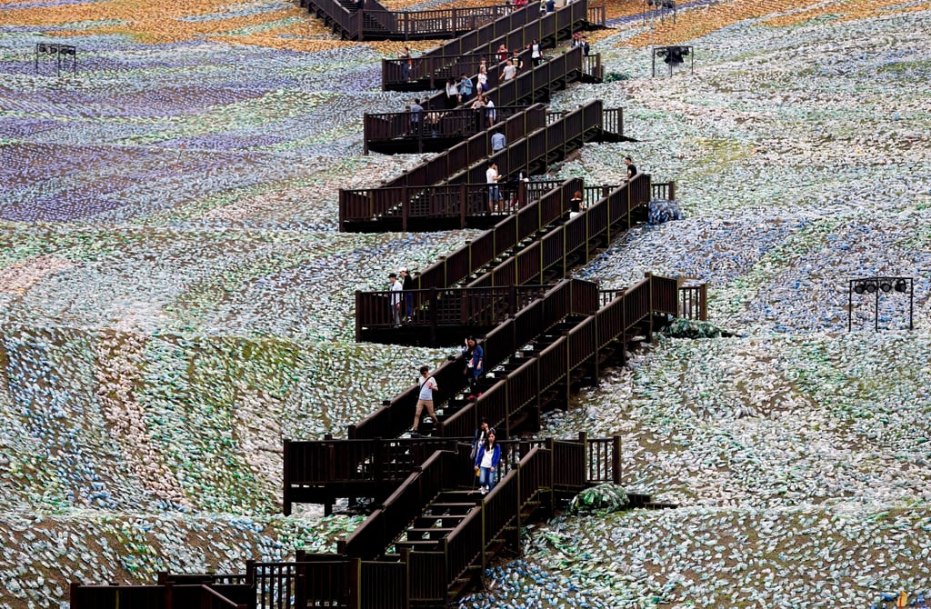 People walk around the Starry Paradise park, a recreation of Van Gogh’s “The Starry Night” made from discarded plastic bottles, in Keelung city in Taiwan in 2016. In Taiwan, waste charging and other measures have led to more recycling. Photo: EPA