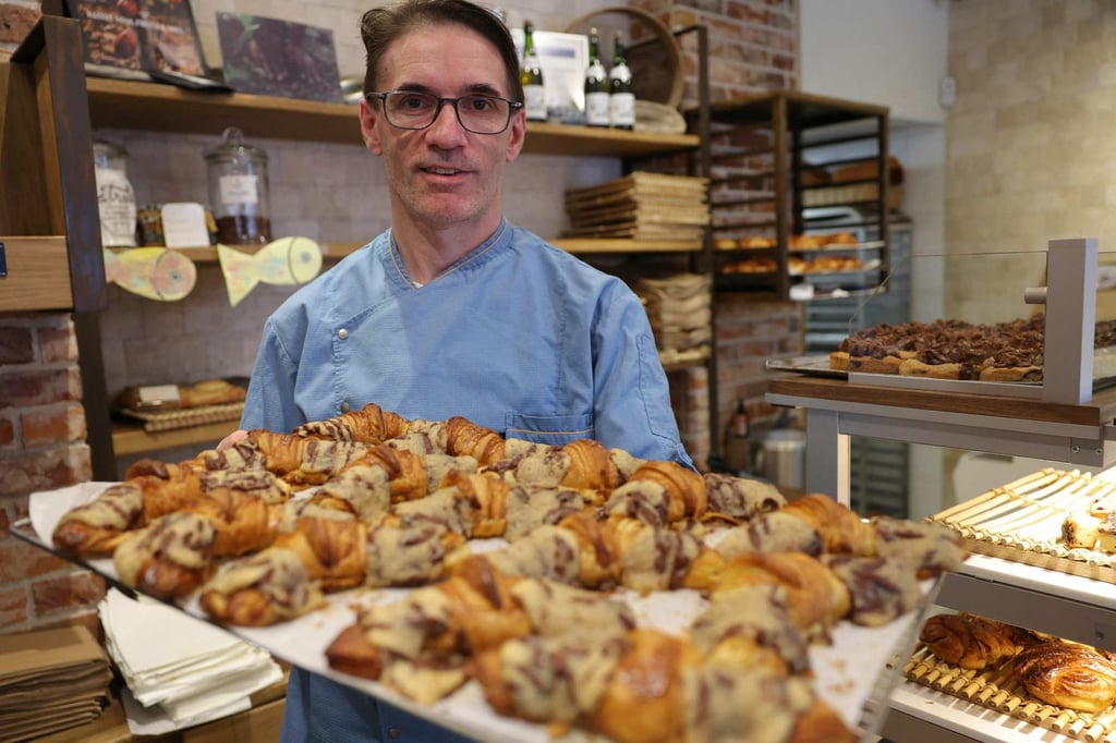 Stephane Louvard with a tray of crookies at his pastry shop in Paris. Photo: AFP Stephane Louvard with a tray of crookies at his pastry shop in Paris. Photo: AFP