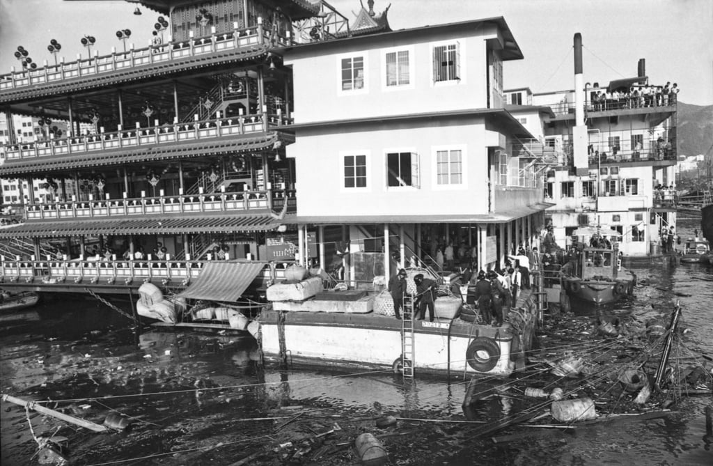 Firefighters on a barge attached to the Jumbo Floating Restaurant survey the remains of a trawler which exploded and sank near the restaurant in Aberdeen. Photo: SCMP Firefighters on a barge attached to the Jumbo Floating Restaurant survey the remains of a trawler which exploded and sank near the restaurant in Aberdeen. Photo: SCMP