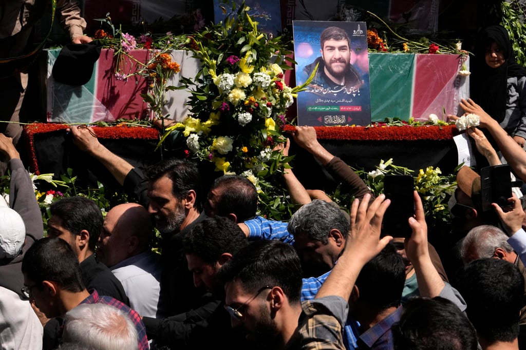 Mourners try on Friday to touch the flag-draped coffins of Revolutionary Guard members killed in an air strike on Iran’s consulate in Syria. Photo: AP