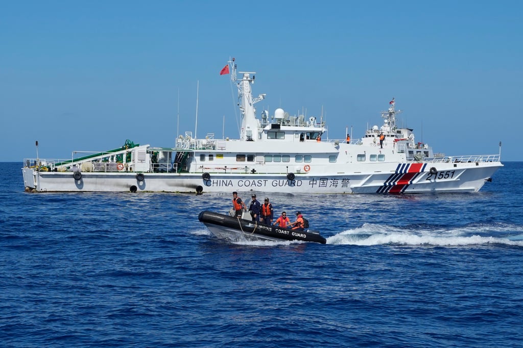 Philippine coastguard personnel on a rubber boat pass by a Chinese coastguard ship after conducting medical treatment to injured crew members of a Philippine resupply vessel which got hurt during a water canon incident in the disputed South China Sea on March 5. Photo: AP