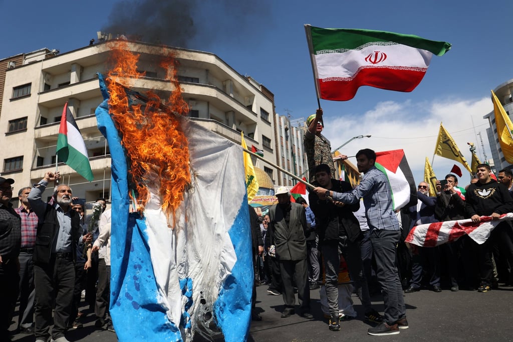 Iranians in Tehran burn an Israeli flag during a rally marking Quds Day and the funeral of members of the Islamic Revolutionary Guard Corps who were killed in an airstrike on the Iranian embassy in Damascus, Syria. Photo: Majid Asgaripour / WANA (West Asia News Agency) via Reuters Iranians in Tehran burn an Israeli flag during a rally marking Quds Day and the funeral of members of the Islamic Revolutionary Guard Corps who were killed in an airstrike on the Iranian embassy in Damascus, Syria. Photo: Majid Asgaripour / WANA (West Asia News Agency) via Reuters