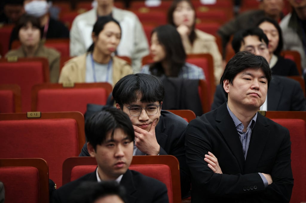 Staff of the ruling People Power Party react as they watch the results of exit polls. Photo: Reuters Staff of the ruling People Power Party react as they watch the results of exit polls. Photo: Reuters