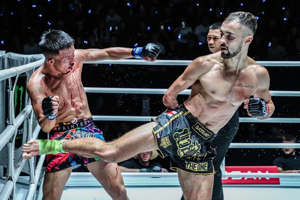 Jake Peacock lands a strong kick on bloodied Kohei Shinjo in Bangkok. Photo: ONE Championship