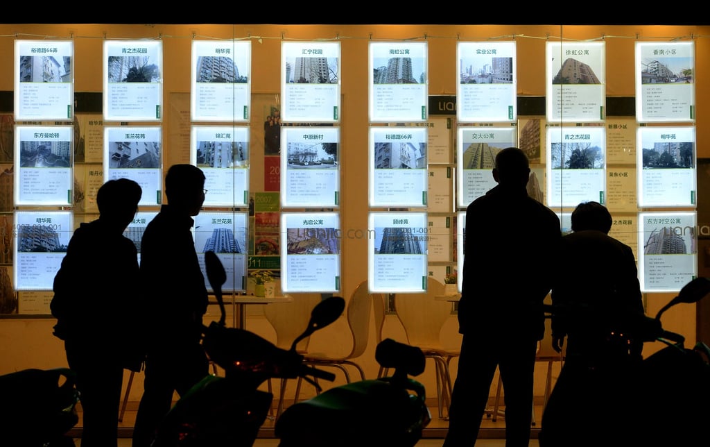 People viewing second-hand home listings outside a Lianjia outlet in Shanghai on March 2024. Photo: SCMP People viewing second-hand home listings outside a Lianjia outlet in Shanghai on March 2024. Photo: SCMP