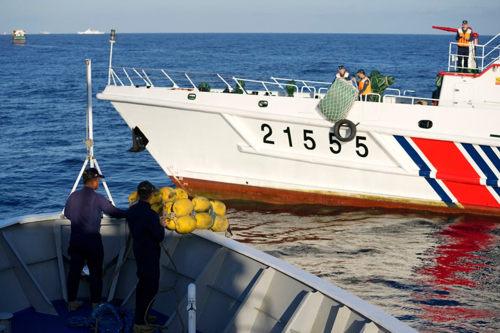 Crew members of Philippine coastguard BRP Sindangan prepare rubber fenders as a Chinese coastguard ship tries to block its path to enter the Second Thomas Shoal in the disputed South China Sea on March 5. Photo: AP