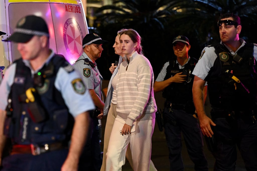Members of the public are escorted by police from a Sydney shopping centre after multiple stabbings inside the building. Photo: EPA-EFE