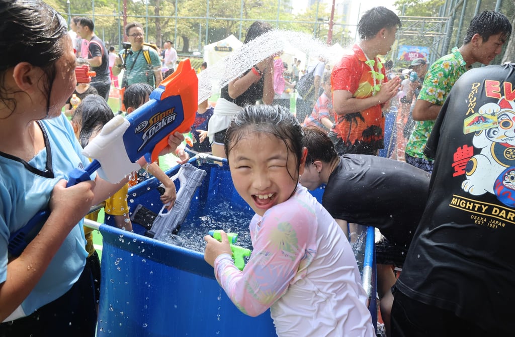 The water splashing with buckets and water guns has been confined to basketball courts in Carpenter Road Park. Photo Dickson Lee The water splashing with buckets and water guns has been confined to basketball courts in Carpenter Road Park. Photo Dickson Lee