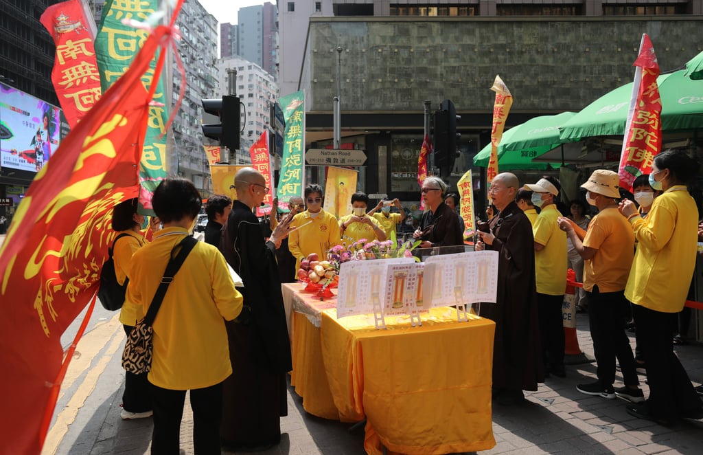 Buddhists pray for the victims killed in the fire at New Lucky House. Photo: Xiaomei Chen