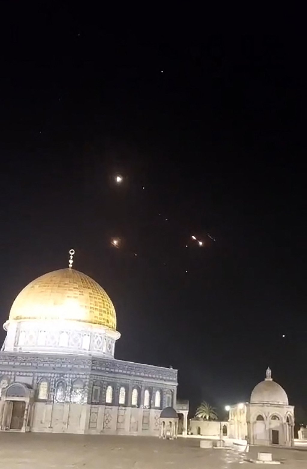 Rocket trails in the sky above the Al-Aqsa Mosque compound in Jerusalem. Photo: AFP