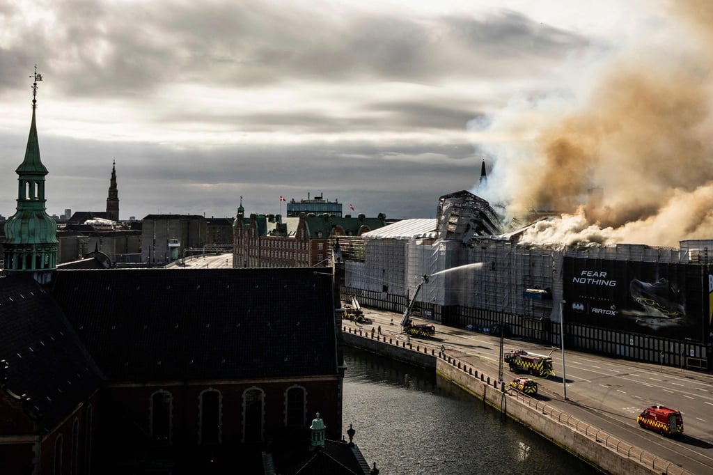 Plumes of smoke billow from the historic Boersen stock exchange building. Photo: AFP Plumes of smoke billow from the historic Boersen stock exchange building. Photo: AFP