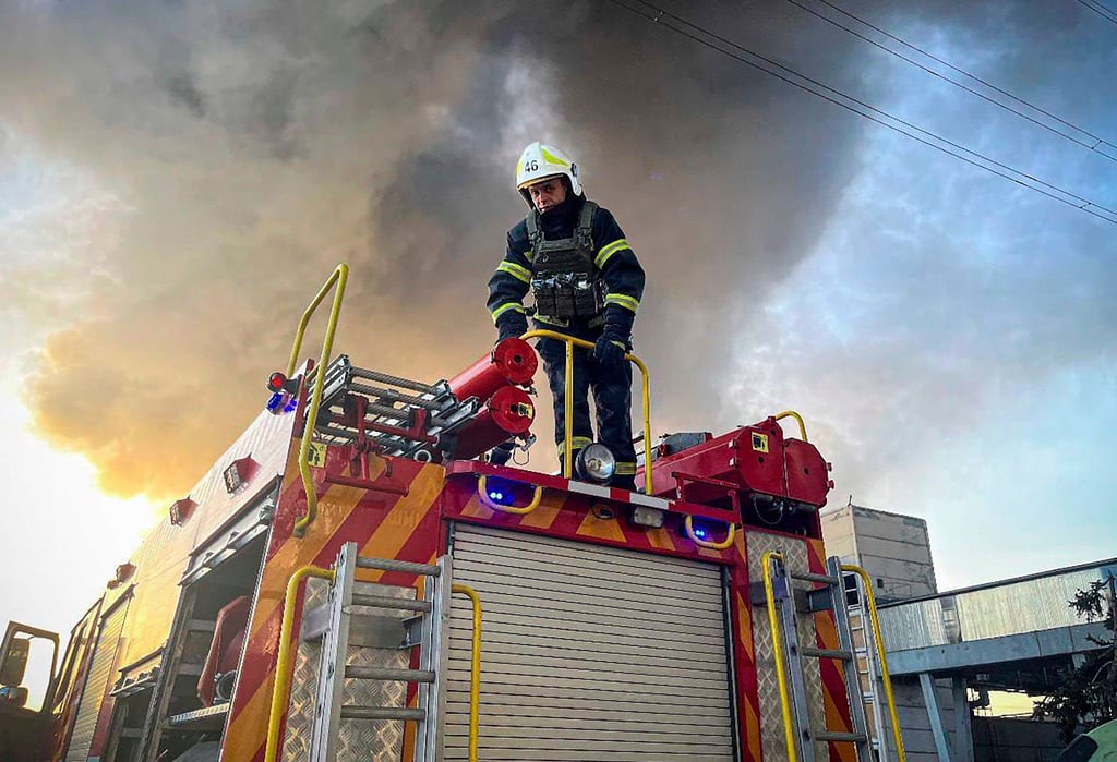An emergency worker extinguishes a fire after a Russian attack on the Trypilska thermal power plant. Photo: Ukrainian Emergency Service via AP An emergency worker extinguishes a fire after a Russian attack on the Trypilska thermal power plant. Photo: Ukrainian Emergency Service via AP