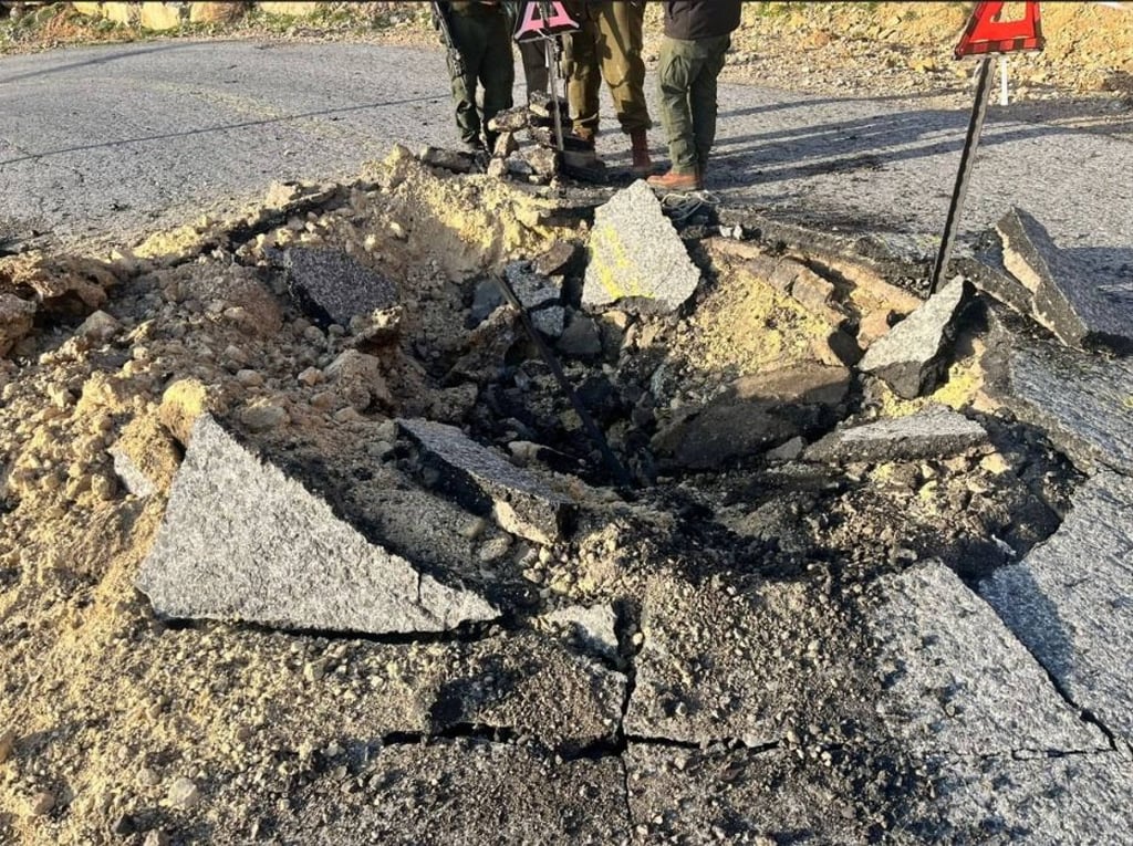 A crater in a road after Iran’s missile strike on Israel. Photo: Israel Defence Forces via dpa