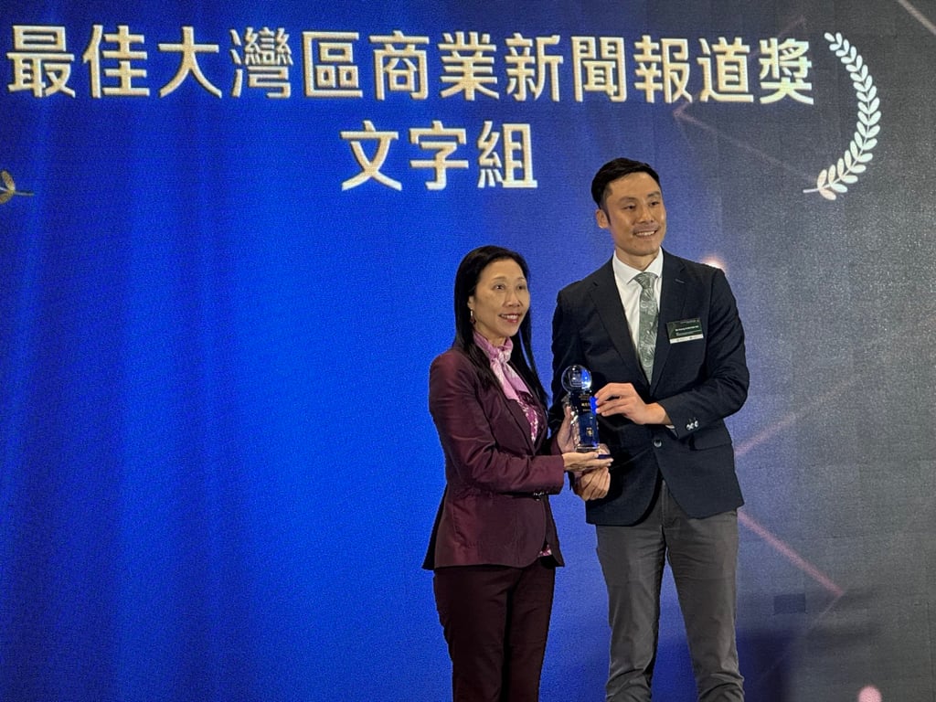 The South China Morning Post’s Enoch Yiu received her gold award in the category of Best Greater Bay Area Business News Reporting category from the Kowloon Motor Bus Company’s head of corporate communications and public affairs Kenny Kan Hok-hei on April 18, 2024. Photo: Peggy Sito. The South China Morning Post’s Enoch Yiu received her gold award in the category of Best Greater Bay Area Business News Reporting category from the Kowloon Motor Bus Company’s head of corporate communications and public affairs Kenny Kan Hok-hei on April 18, 2024. Photo: Peggy Sito.