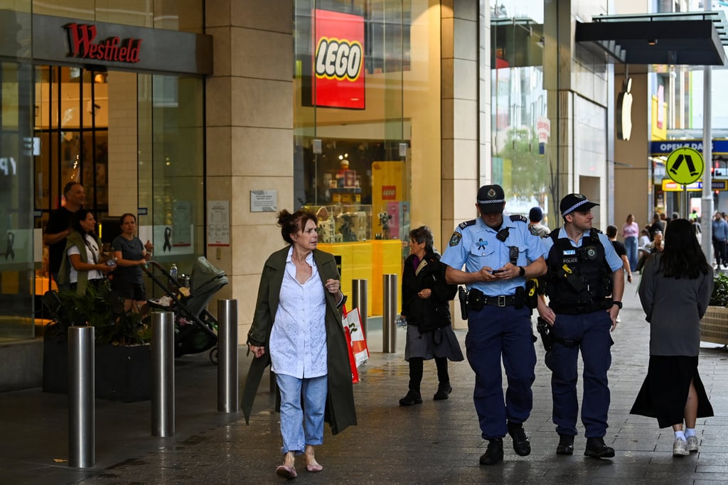 Police officers walk outside the Westfield Bondi Junction shopping centre as it reopens to the public for the first time after the stabbing attacks which killed several people at the shopping centre, in Sydney, Australia, on Friday. Photo: Reuters