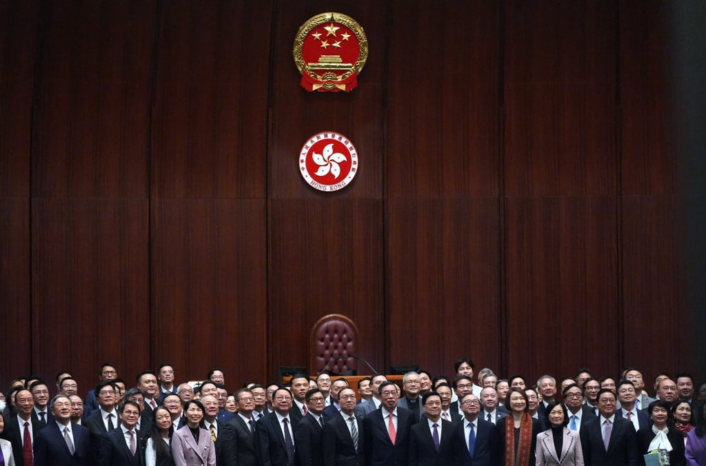 Chief Executive John Lee and lawmakers mark the passage of the Article 23 law in the Legislative Council in March. Photo: Eugene Lee