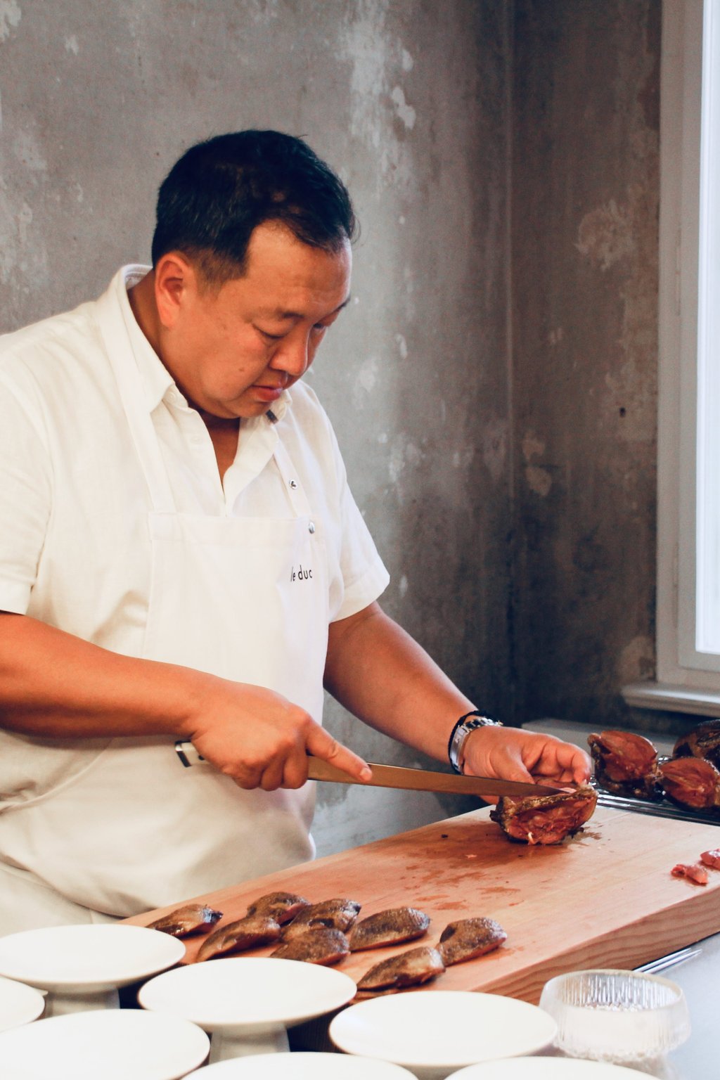 The Duc Ngo prepares pigeons at Le Duc Salon, in Berlin, Germany. Photo: Marietta Arellano The Duc Ngo prepares pigeons at Le Duc Salon, in Berlin, Germany. Photo: Marietta Arellano