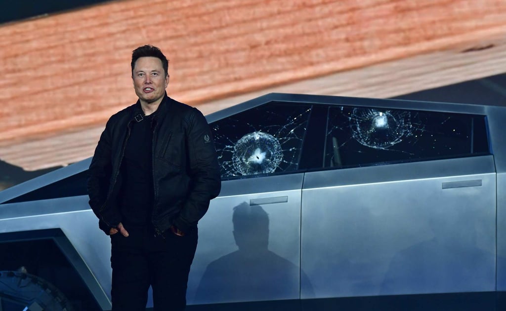 Tesla co-founder and CEO Elon Musk stands in front of the shattered windows of the newly unveiled all-electric battery-powered Tesla’s Cybertruck on November 21, 2019. Photo: AFP