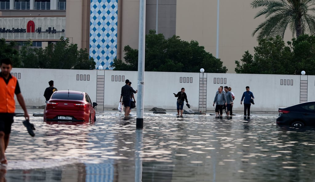 Pedestrians walk near flooded roads after heavy rainfall in Dubai. Photo: EPA-EFE Pedestrians walk near flooded roads after heavy rainfall in Dubai. Photo: EPA-EFE