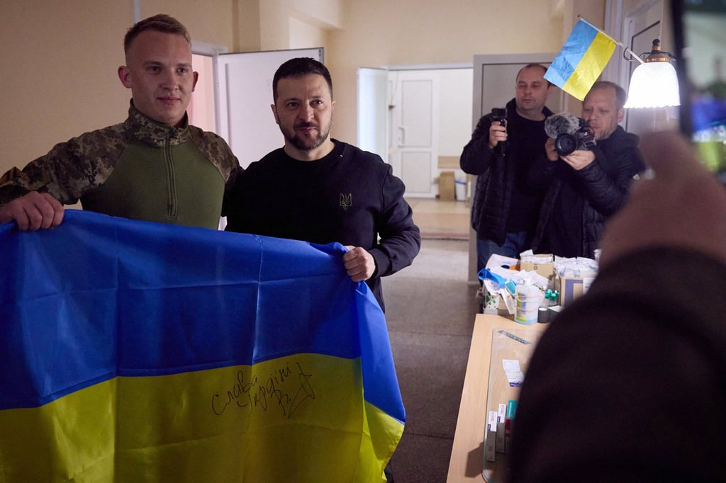 Ukraine’s President Volodymyr Zelensky (centre) with a soldier at a medical company in Donetsk region, amid the Russian invasion of Ukraine. Photo: Handout / Ukrainian Presidential Press Service / AFP